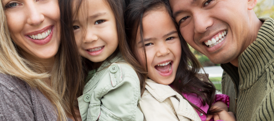 A family of four smiling