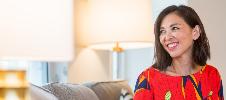 woman smiling on a sofa