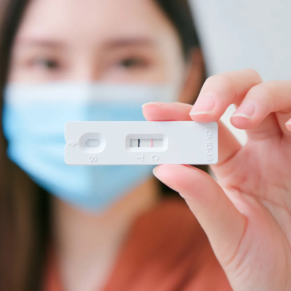 Woman holding positive Covid-19 test