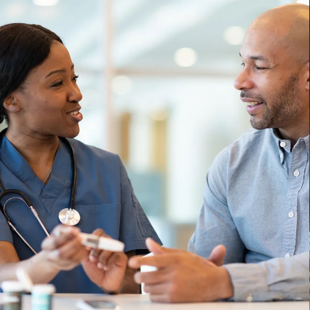 Doctor showing patient how test their blood sugar