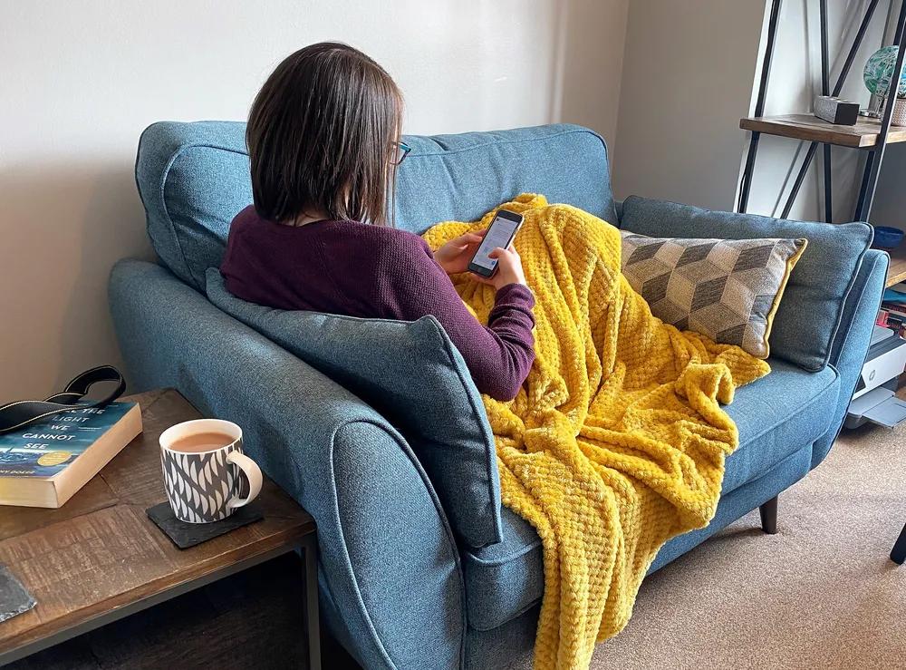 Woman on Phone under blanket