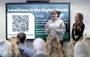 Two Young People Advisory Group members presenting about Loneliness in the digital world